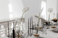minimalist wedding centerpieces of white anthuriums and tall and thin candles are amazing for a minimalist wedding