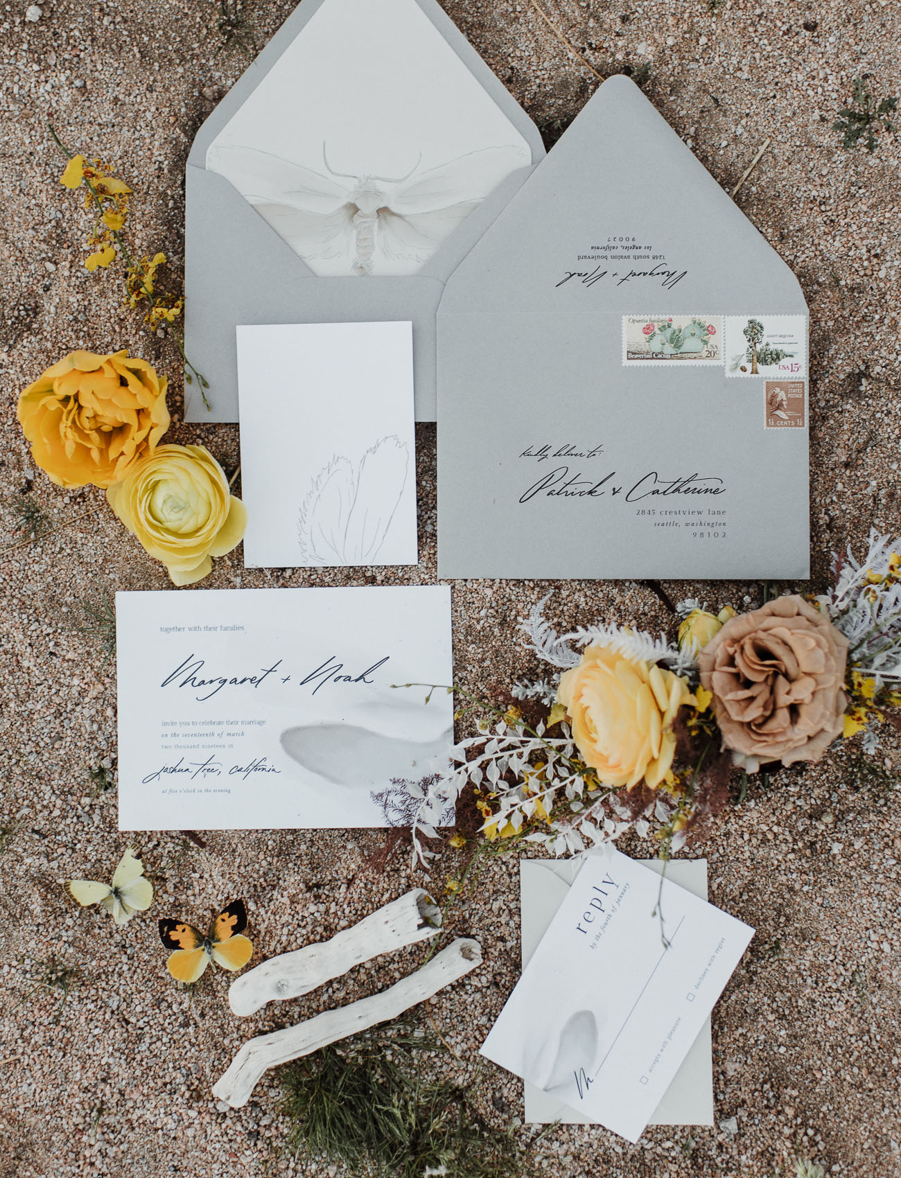 The wedding invitation suite was done in grey and white, with black calligraphy and insect prints