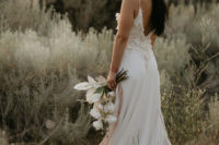03 The bride was wearing a modern spaghetti strap wedding dress with appliques, a cutout back and a train
