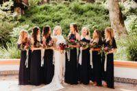 03 The bridesmaids were wearing mismatching black maxi dresses and carrying bright bouquets