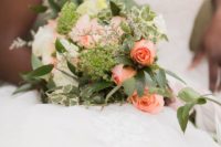 03 The wedding bouquet was done with neutral and coral pink blooms and greenery