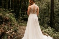 03 a beautiful A-line wedding dress with a lace cutout back, a plain skirt with lace inserts and a train