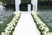 03 a luxurious modern wedding aisle with a white runner, fresh white roses, ghost chairs and a matching white geometric arch