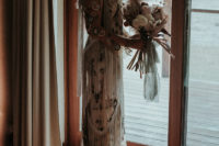 04 The bride was wearing a neutral wedding dress by Rue De Seine with colorful botanical embroidery and super long fringe