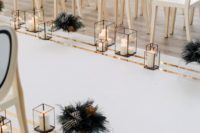 04 a modern luxurious wedding aisle with candle lanterns, dark foliage and elegant white and black chairs