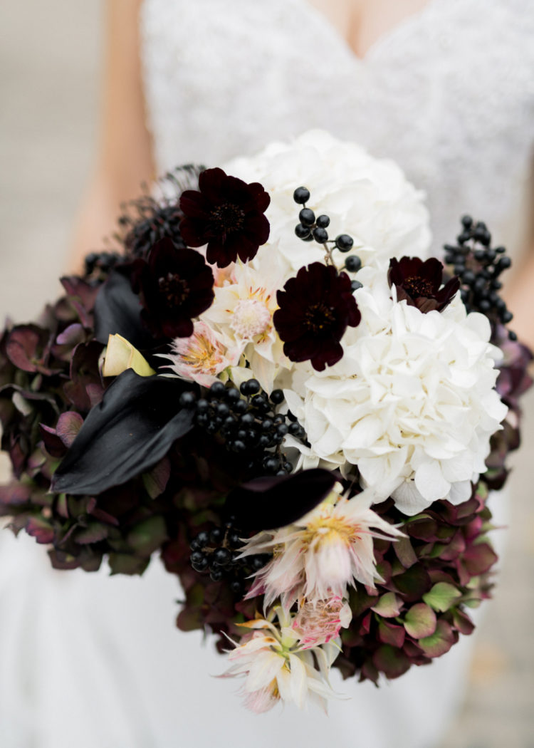 The wedding bouquet was done with black callas, berries, dark hydrangeas and white and blush blooms