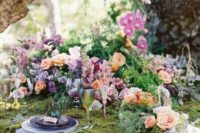 06 a beautiful enchanted forest wedding tablescape with moss, bright blooms all over and greenery loooks wild and natural