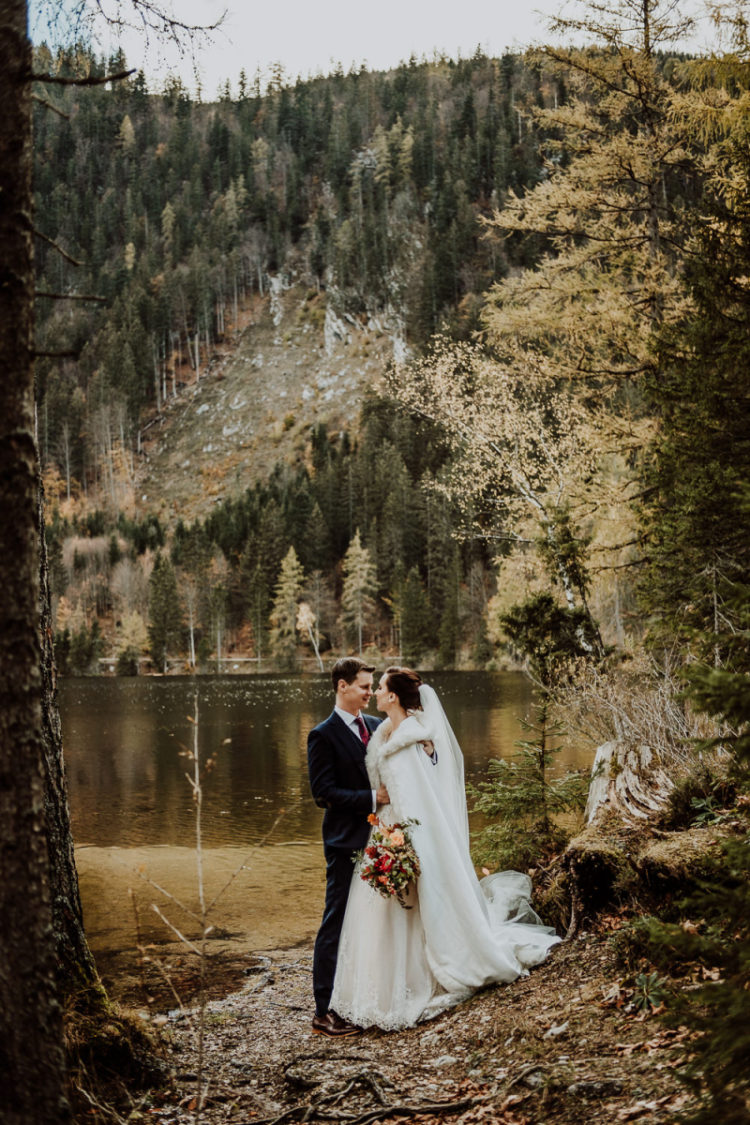 The bride covered up with a long white coat with faux fur to feel comfortable during outdoor shots