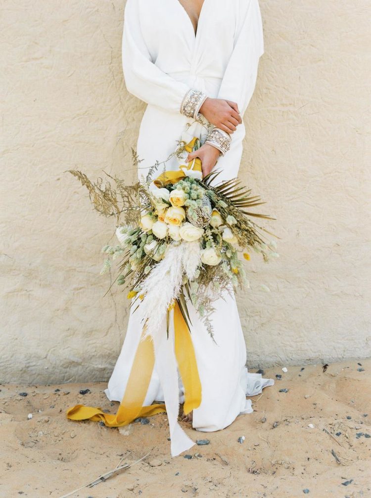 The wedding bouquet was done with dried blooms and leaves, pampas grass and peach flowers