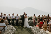 07 The wedding ceremony took place outdoors, with pale greenery and white blooms that also lined the aisle