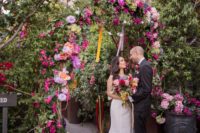 08 The wedding gate was done with super bright florals and ribbons