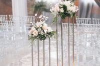 08 clear chairs with vintage design, a printed runner and florals on tall stands plus floating candles down for a romantic meets modern look