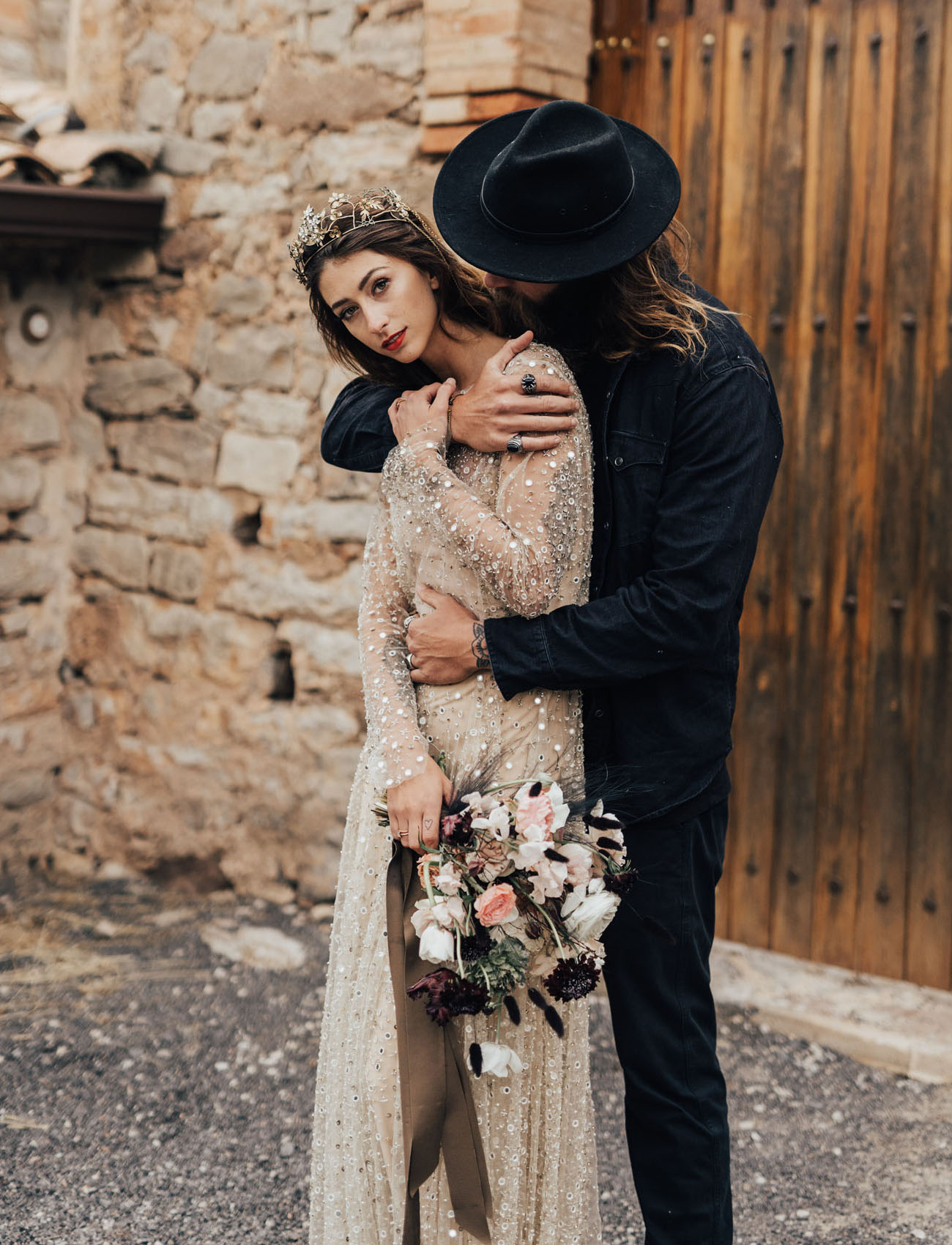 The groom was wearing a total black look with a hat, and the bride rocked a gorgeous embellished crown