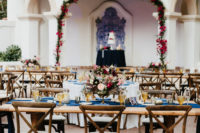 09 The wedding reception was done with uncovered wooden tables and elegant cjairs, navy runners and amber glasses