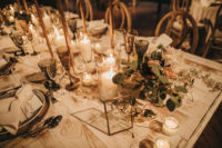 09 The wedding table setting was done with candles, greenery, elegant cutlery and chargers