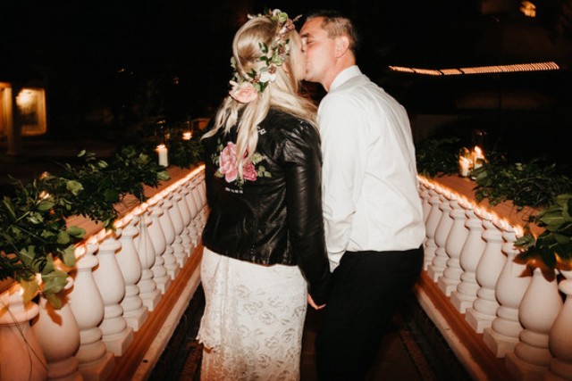 The bride covered up with a black leather jacket
