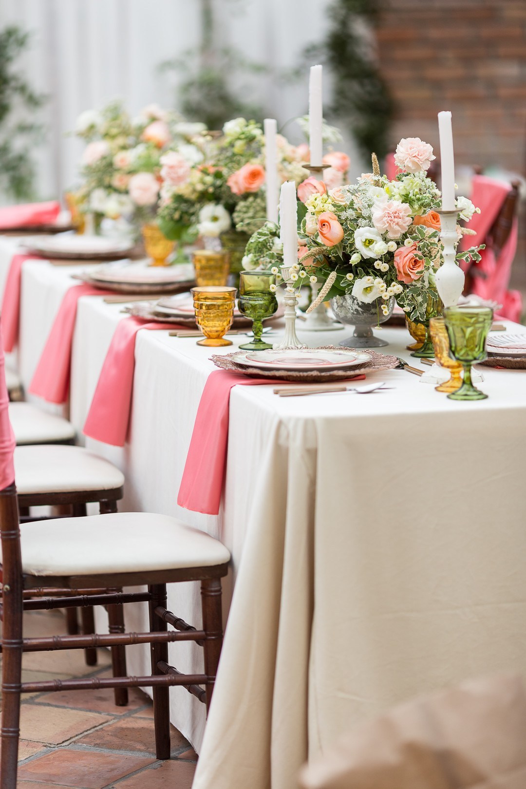 The florals were tender   blush, coral pink and white blooms and some greenery, candles added chic to the setting
