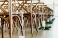 11 decorate your wedding aisle with fresh greenery and candles on the floor and add wooden chairs for a chic look