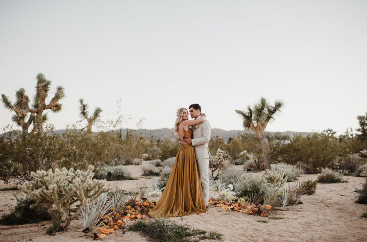 An alternative wedding altar was done with pale foliage, mustard and rust blooms placed on the sand
