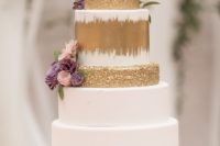 12 The wedding cake was done in white and gold, topped with fresh blooms and greenery plus a copper stand