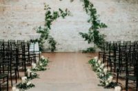 13 laconic decor with greenery, candles and black chairs will make your walking down the aisle stylish