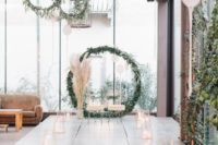 16 a modern meets boho wedding aisle with geometric candle lanterns and candles, pampas grass and greenery