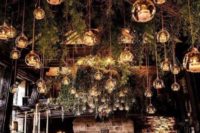18 create an enchanted forest ambience inside with branches and greenery hanging down and candle lanterns all over