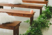23 wooden benches paired with lush greenery and fluffy pillows to create a fresh and welcoming ambience