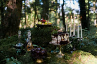 24 an adorable enchanted forest wedding dessert table with a semi naked wedding cake, fruits, alcohol, candles