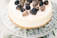 a classic cheesecake topped with gilded blackberries is a yummy dessert that always works for a fall wedding