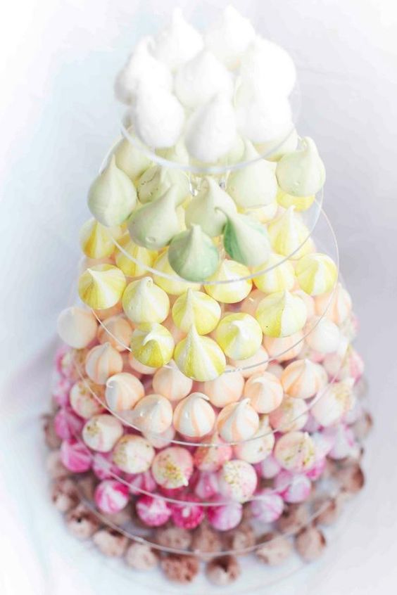 a clear acrylic stand with meringues of various colors is a cool and creative alternative to a usual wedding cake