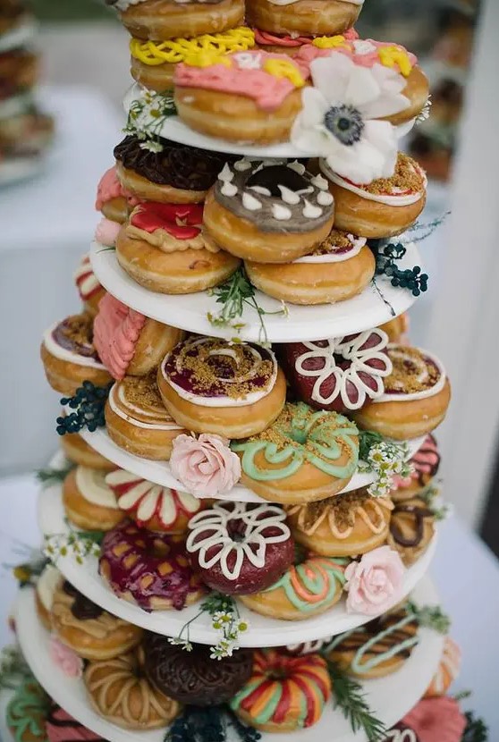 a colorful glazed donut tower in boho style will be a nice alternative to a usual wedding cake, and it's delicious