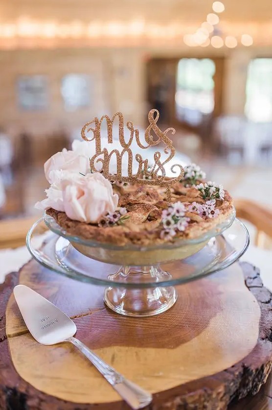 a handmade berry pie topped with pink blooms and a gold glitter calligraphy topper is a lovely idea