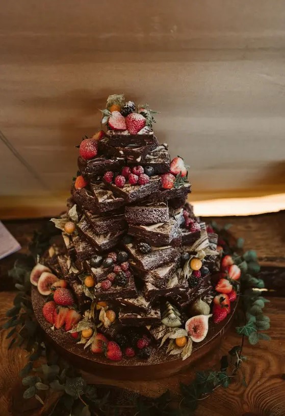 a lovely brownie stack topped with fresh berries, figs, kiwis, some greenery is a gorgeous solution for many relaxed weddings