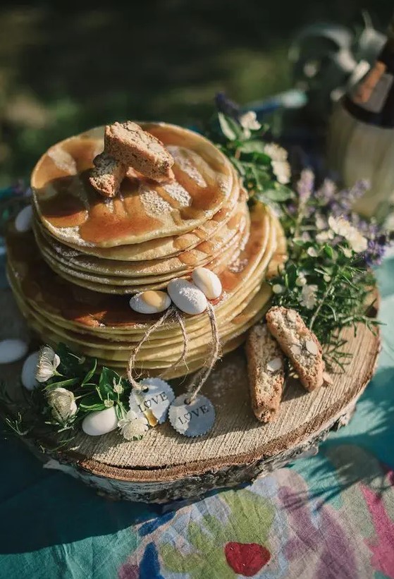 a pancake wedding cake with caramel, candy pebbles, greenery and bread with nuts is a lovely idea for a rustic wedding