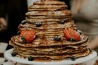a pancake wedding cake with drip and fresh berries is a delicious alternative to a usual wedding cake