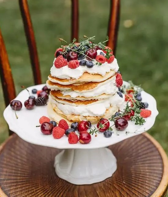 a pancake wedding cake with whipped cream, fresh berries and herbs is a gorgeous idea for a summer wedding