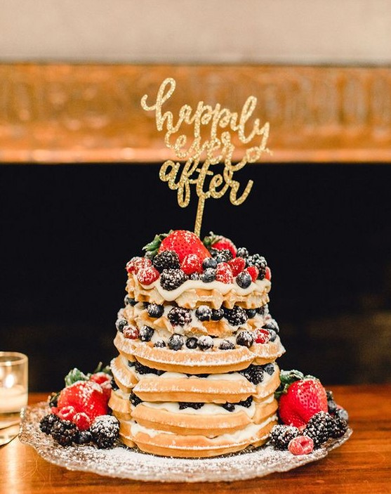 a small yet very tasty waffle wedding cake with strawberries, raspberries, blueberries and blackberries plus a glitter topper