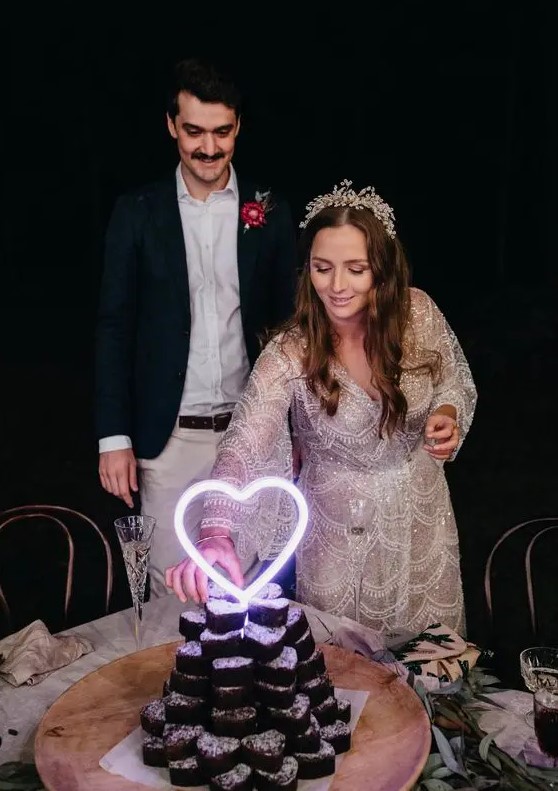 a stack of heart-shaped brownies topped with a neon heart is a perfect solution for a modern wedding with a casual or more relaxed feel