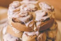 a very simple and cool cinnamon roll wedding cake with white frosting is a lovely alternative to a usual wedding cake