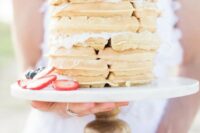 a waffle wedding cake topped with strawberries and blueberries is a cute and delicious idea