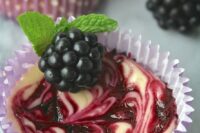 mini blackberry swirl cheesecakes topped with blackberries and mint are perfect for a fall wedding