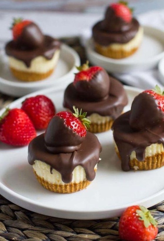 mini cheesecakes topped with chocolate and with fresh strawberries are very tasty and feature a classic taste