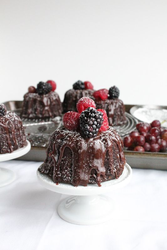 mini chocolate bundt cakes with chocolate drip and fresh berries on top are adorable for a wedding, they look and taste delicious