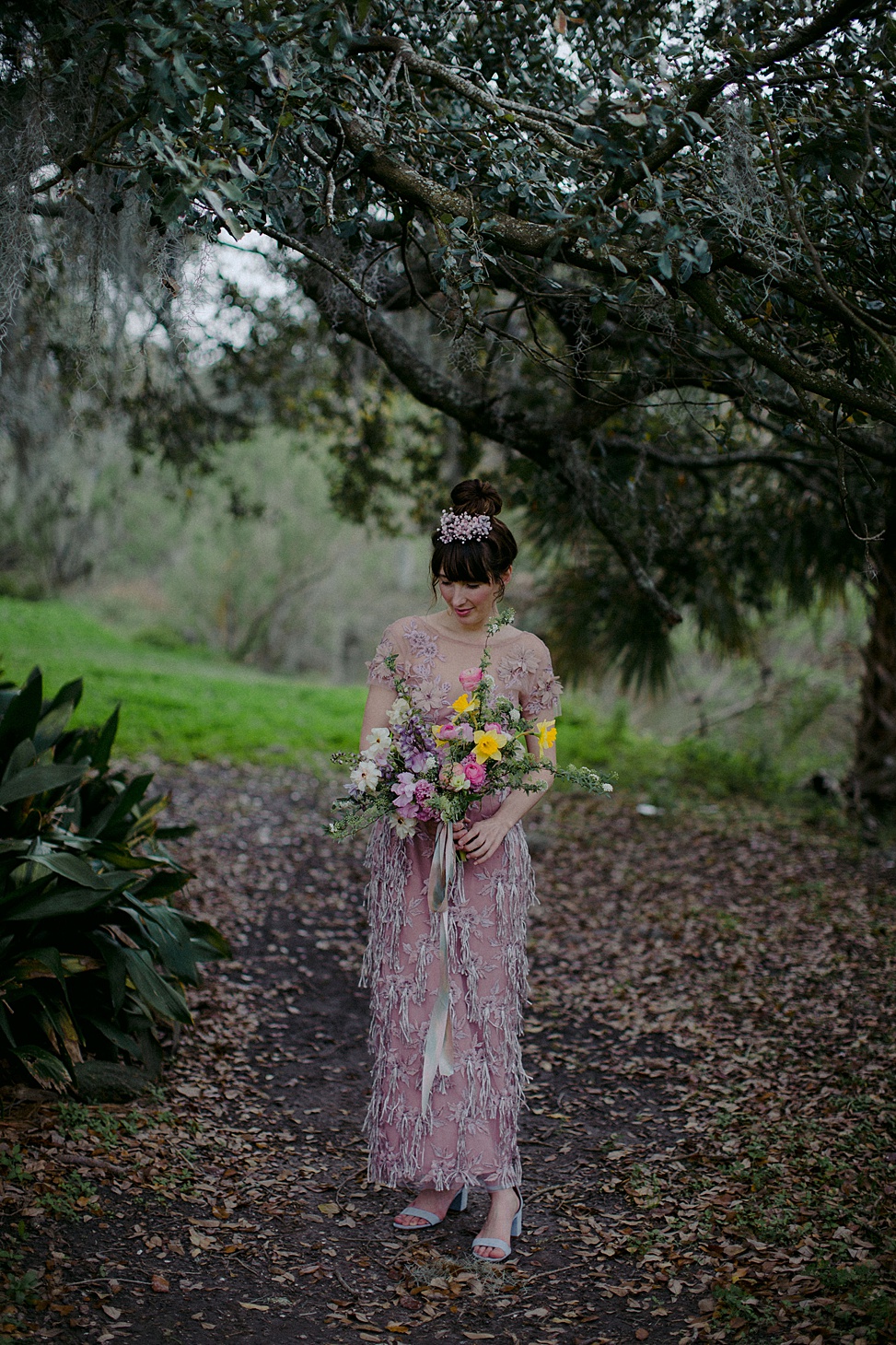The bride was wearign a mauve beaded and applique sheath wedding dress and blue shoes