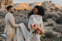 02 The bride was wearing a slip dress with a lace cape, nude heels and the groom was wearing a neutral suit with a floral tie and neutral boots