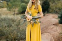 a modern marigold wedding dress with short sleeves and a front slit by Sarah Seven