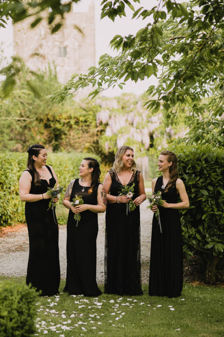 The bridesmaids were wearing mismatching black maxi dresses to match the gorgeous wedding gown