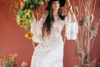 06 The second bridal look was done with a beautiful embroidered wedding dress with a cold shoulder and a black hat