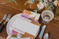 08 The wedding tablescape was done with bright florals, bright cards and napkins in the colors of the wedding shoot